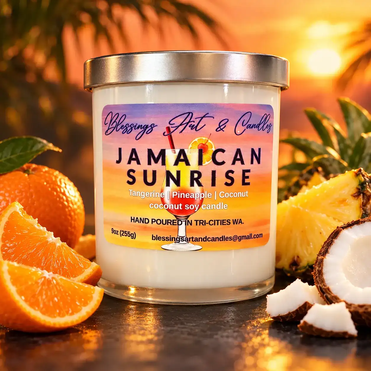Jamaican Sunrise candle with a sunset label, next to oranges, pineapple and coconut