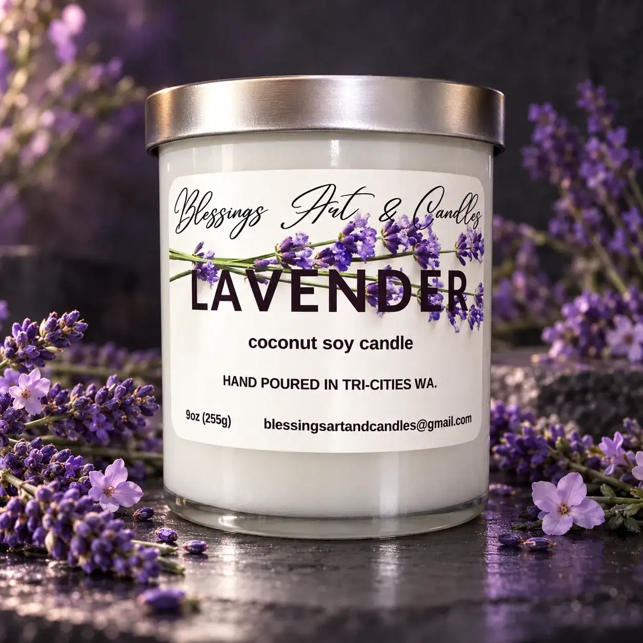 Lavender candle in a glass jar with a silver lid, surrounded by sprigs of lavender