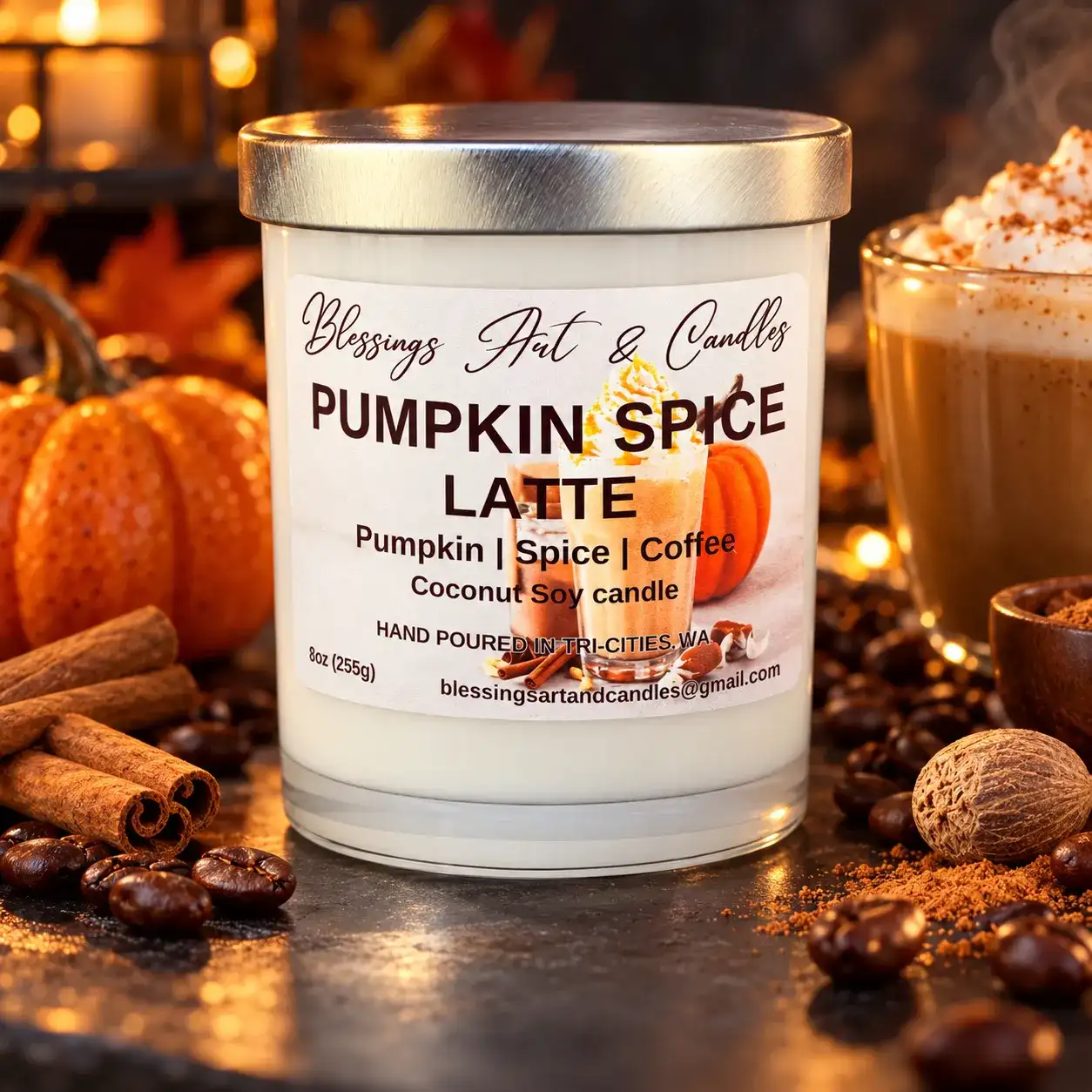 Pumpkin Spice Latte candle in a glass jar with a small pumpkin, cinnamon sticks and coffee beans