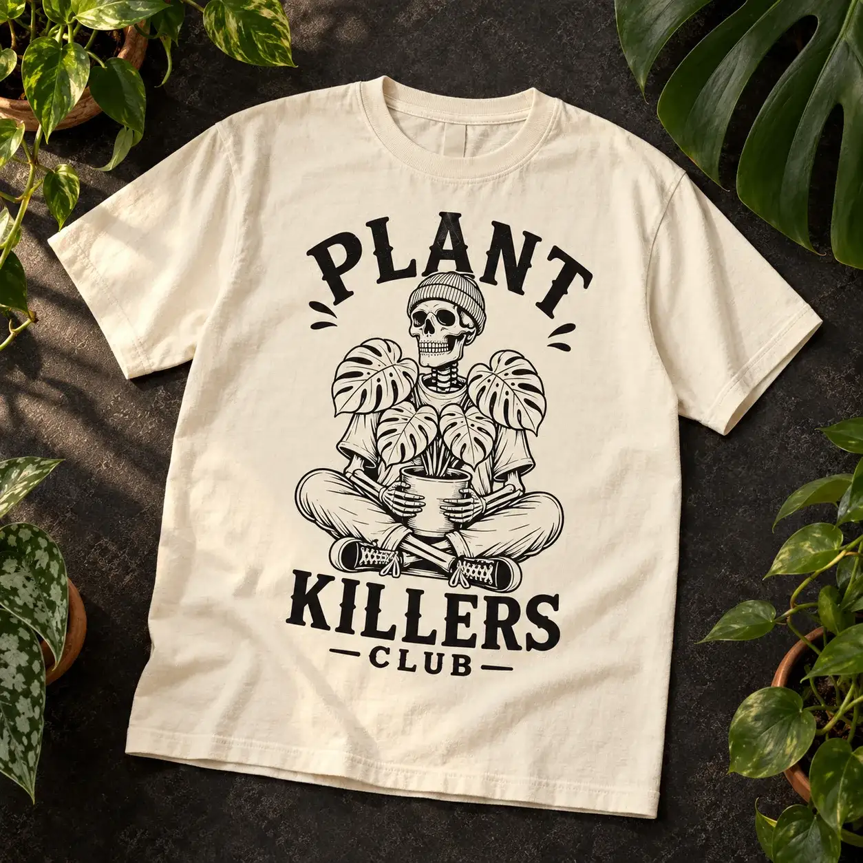 Cream Plant Killers Club tee with a black skeleton and monstera print