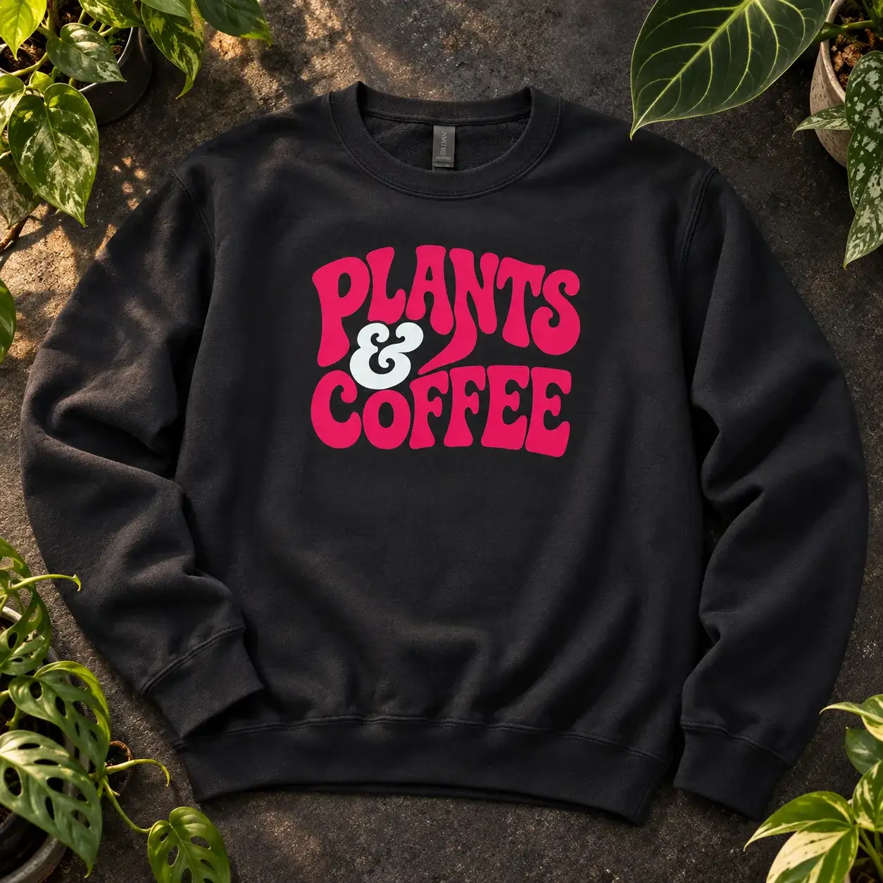 Black crewneck with Plants and Coffee in hot pink retro lettering