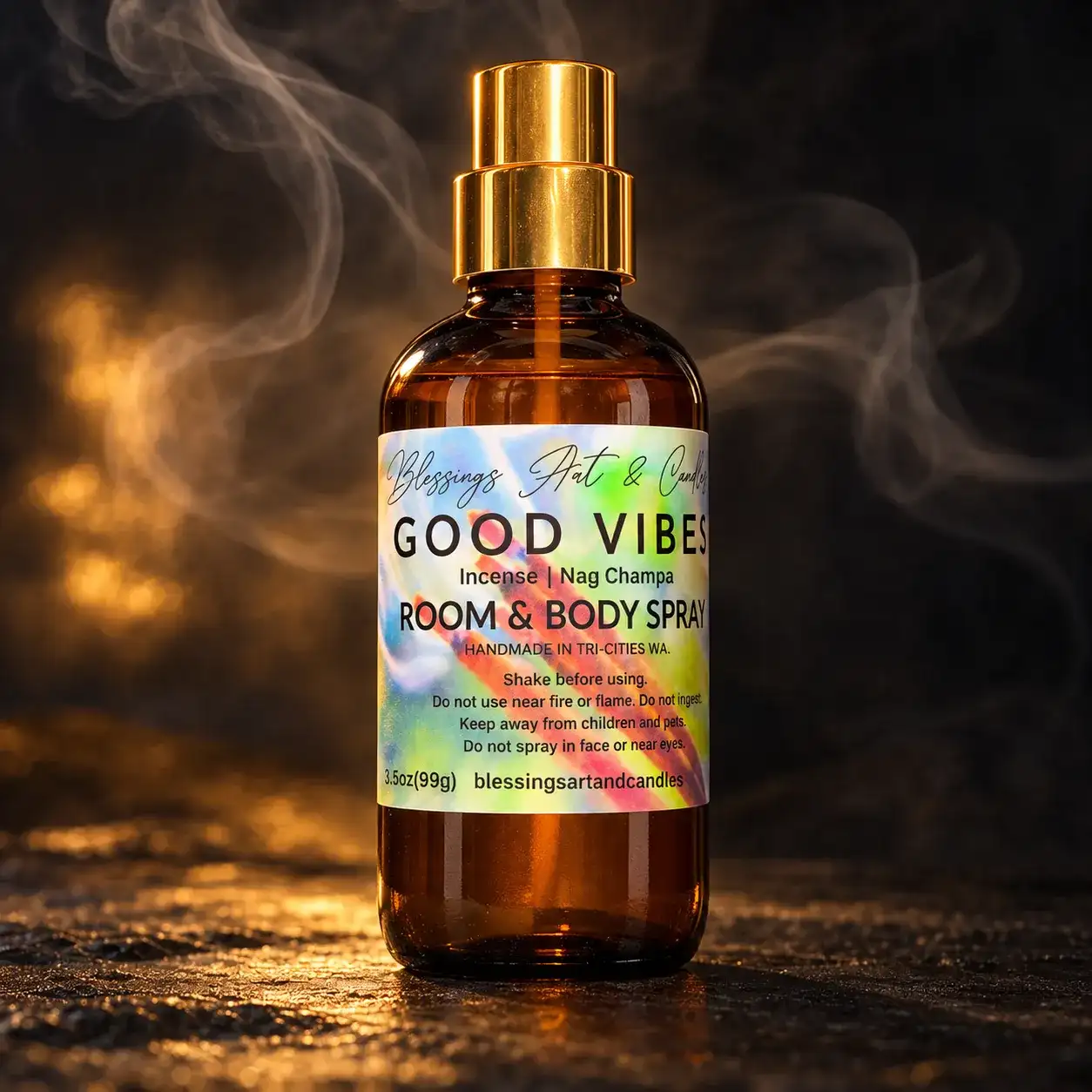 Good Vibes room and body spray in an amber glass bottle with a tie-dye label, in a wisp of smoke