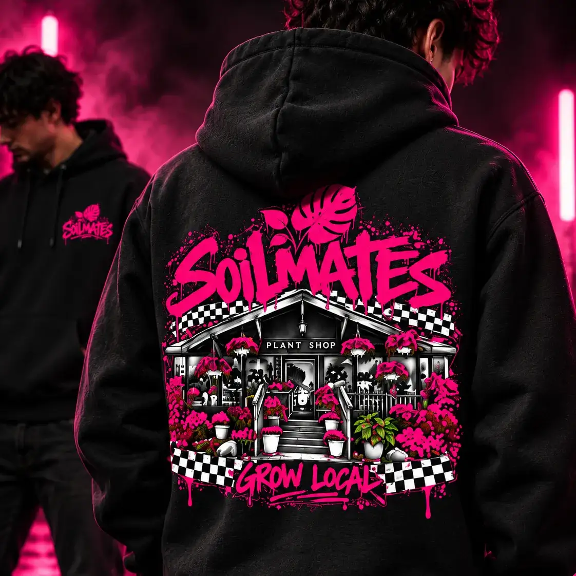 Back of the black SOILMATES Street Hoodie, worn: SOILMATES in hot pink graffiti over a drawing of our storefront, with checkered banners and Grow Local